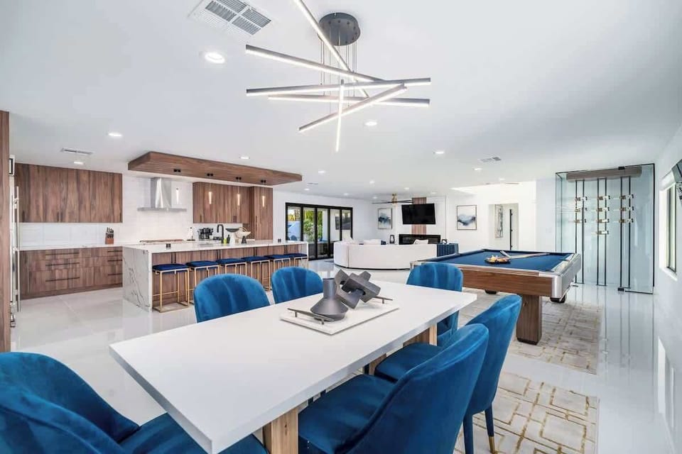 Gather around the dining table for meals and games, with a full gourmet kitchen at your fingertips and a stylish billiards table ready for friendly competition nearby.
