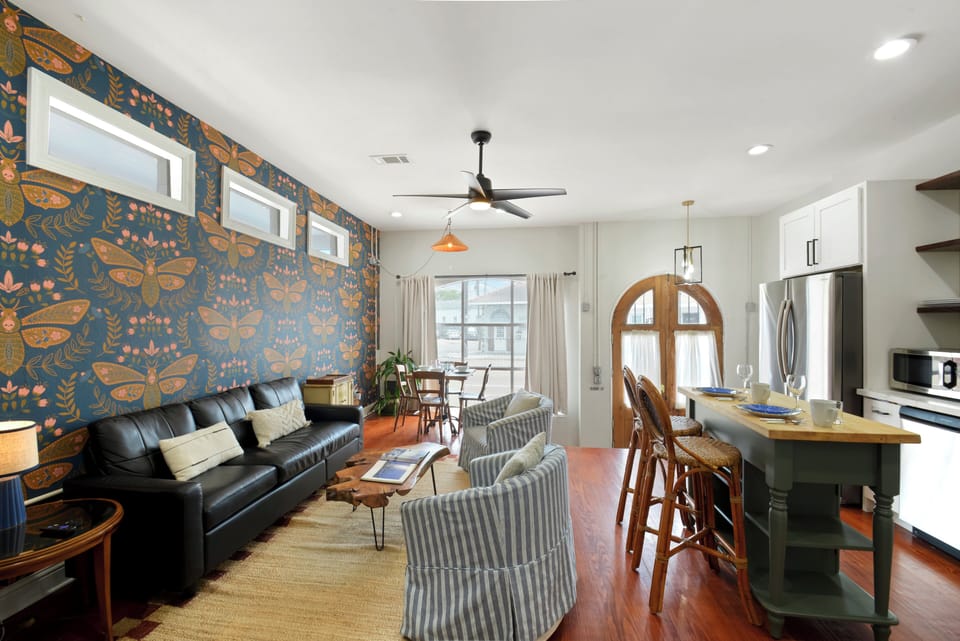 Living into Kitchen- seating for 10+, wall mounted smart TV w/ streaming service