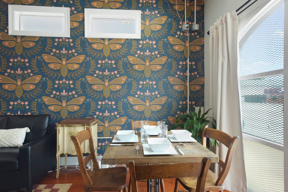 Dining Area- set up for 4, overhead light, stylish wallpaper, TV view