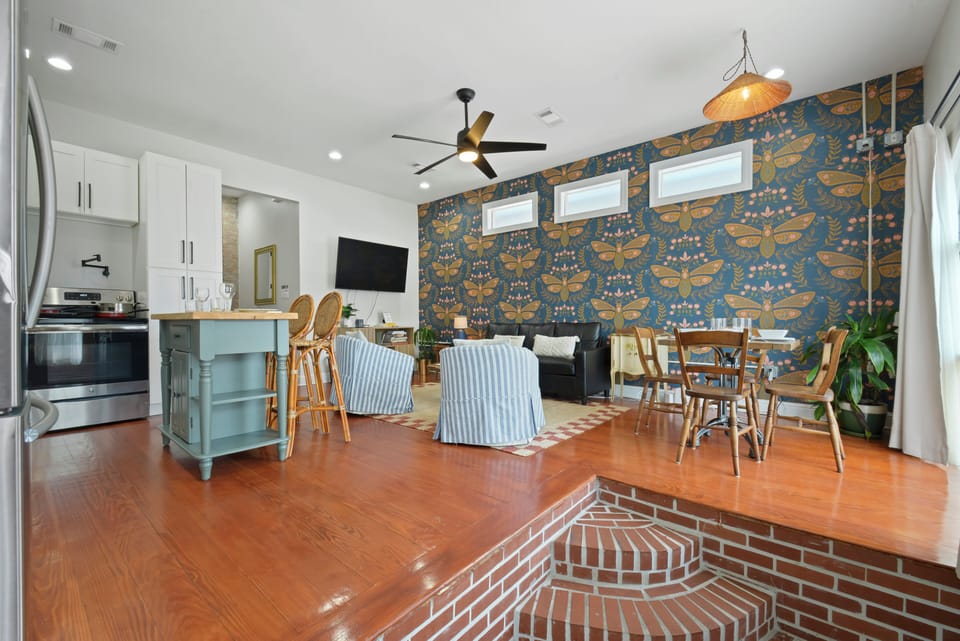 Living into Kitchen- seating for 10+, wall mounted smart TV w/ streaming service