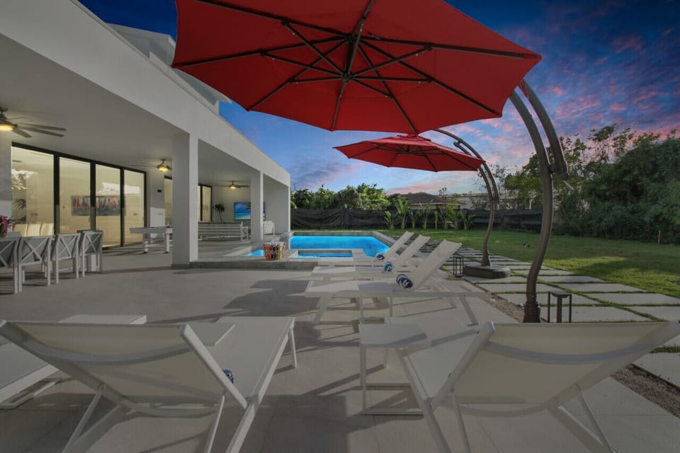 Evening picture from terrace with lounge chairs and swimming pool and Jacuzzi. All pictures are actual pictures NOT renderings!