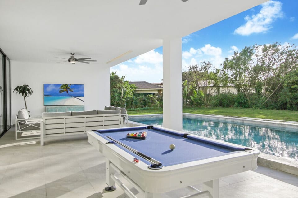 terrace area with pool table, lounge area with 86" smart tv and swimming pool. All pictures are actual pictures NOT renderings!