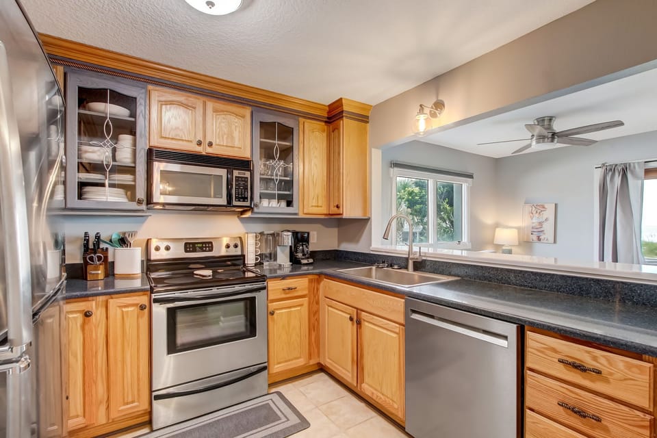 Fully Equipped Kitchen with Stainless Appliances Overlooking Living Area