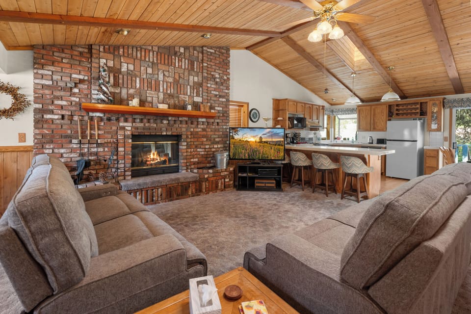 Living Room - Comfortable open living room with new couches, TV, vaulted ceilings and an open floor plan. Additional Sleeping – Two couches, one is a sofa sleeper