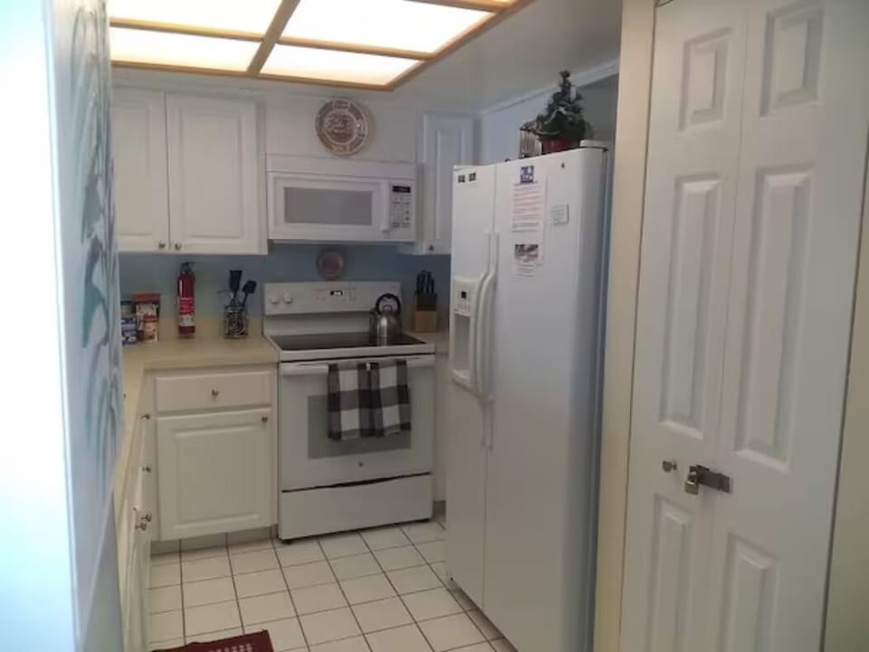 Kitchen area includes big refrigerator/freezer/icemaker and dishwasher