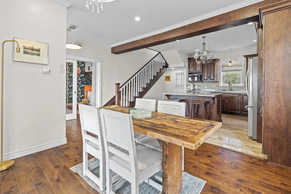Seamless blend of dining, kitchen, and a captivating living space with a staircase backdrop 🍽️✨