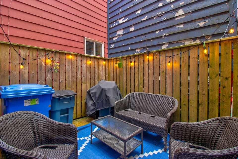 The outdoor balcony is a serene, welcoming space for private retreat. Surrounded by high railing, it offers an unobstructed view of the skyline. The floor is made of smooth, weather-resistant decking. 
The balcony is furnished with a mix  of comfortable seating and practical touches. 