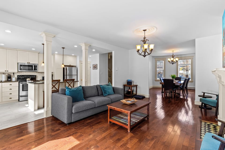 Open-concept living space with comfortable sofa and warm hardwood floors