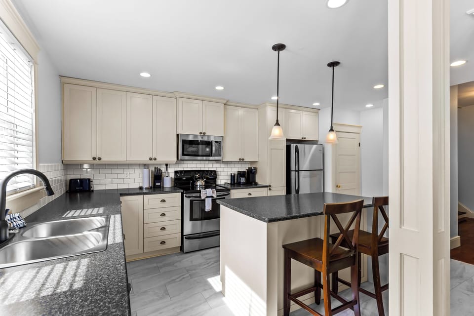 Fully equipped modern kitchen with stainless steel appliances and granite countertops