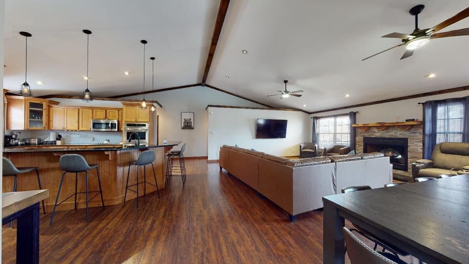 The open-concept living room and kitchen create a bright, inviting space where guests can cook, dine, and relax together