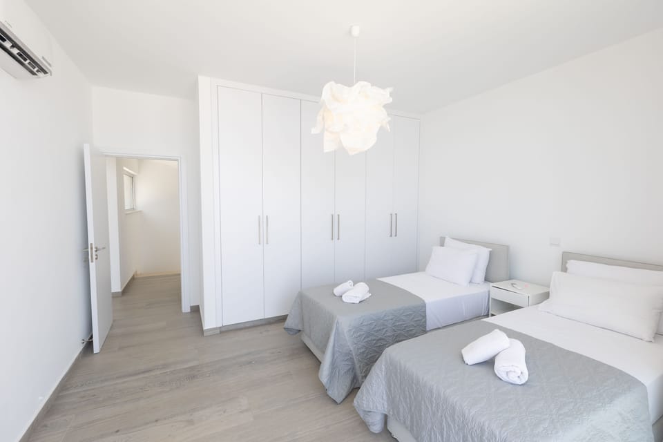 Bedroom 3 with two single beds and balcony access