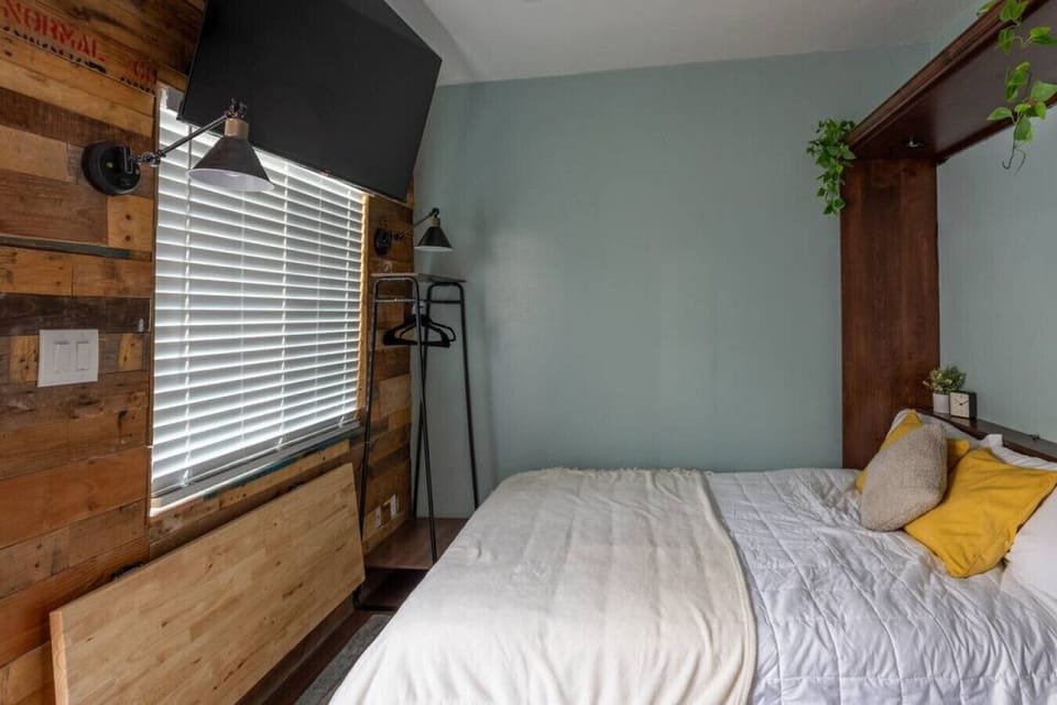 Queen murphy bed up w/ folding work desk.