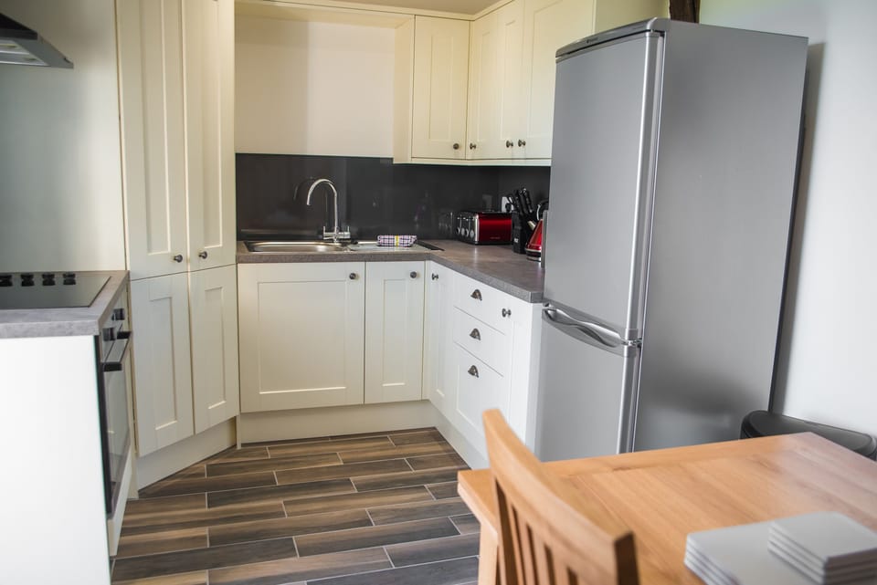 Fridge, electric kettle, toaster, cookware/dishes/utensils
