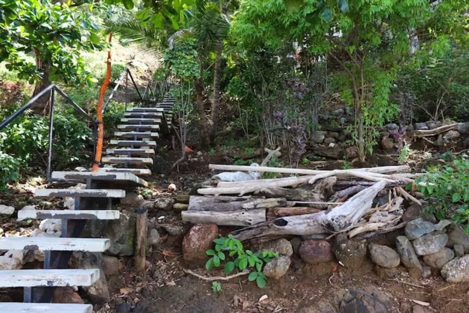 Stairs to the beach with a shower to clean feet, etc