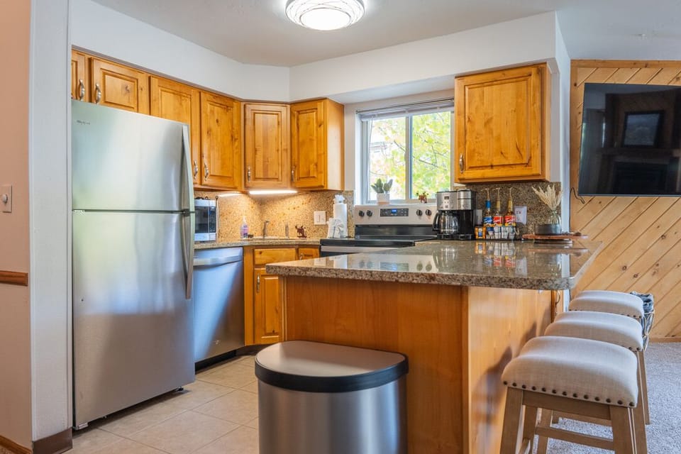Full kitchen with granite countertops.

