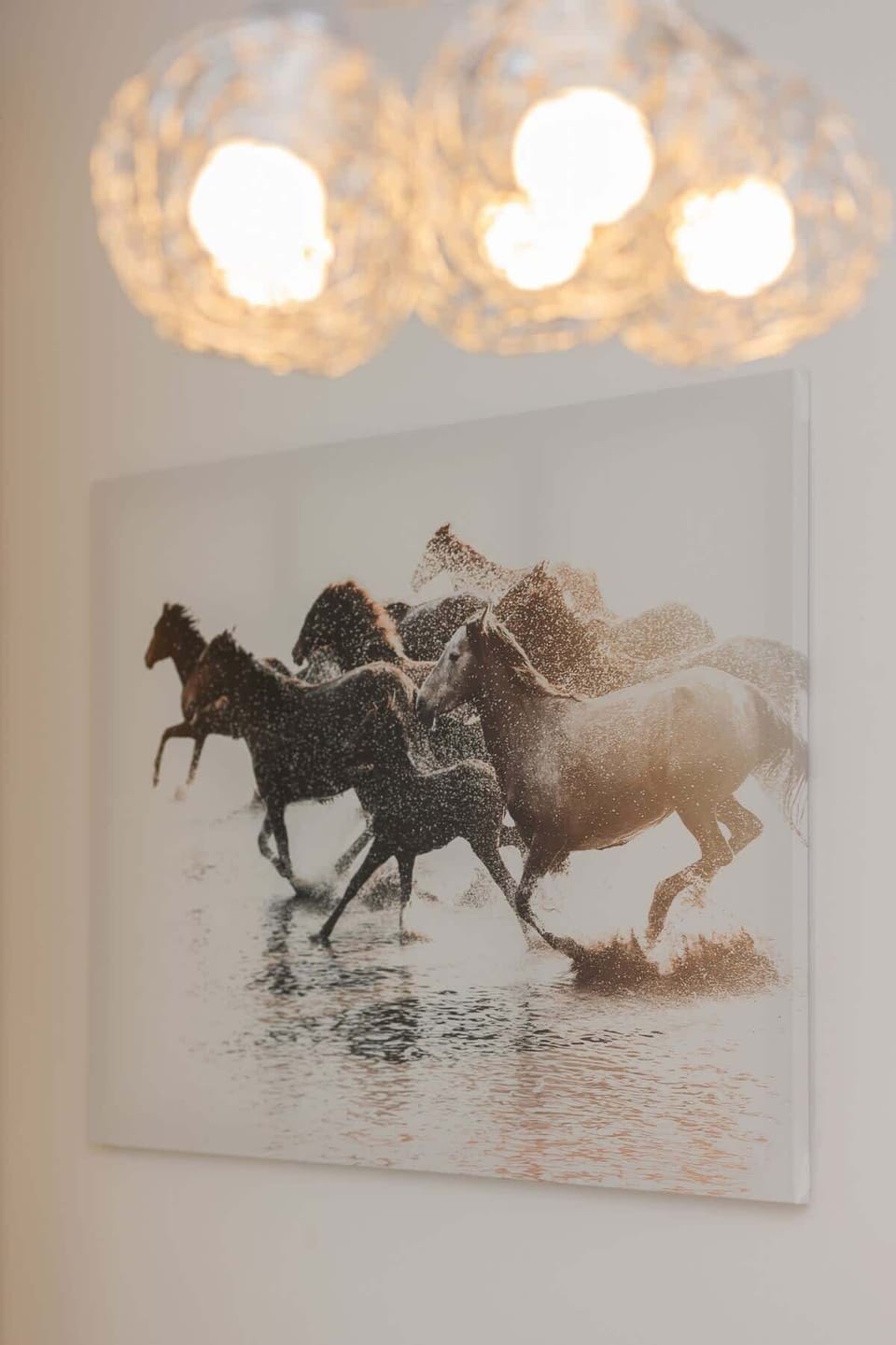 A decorative wall art piece featuring horses, adding character and a unique touch to the decor.
