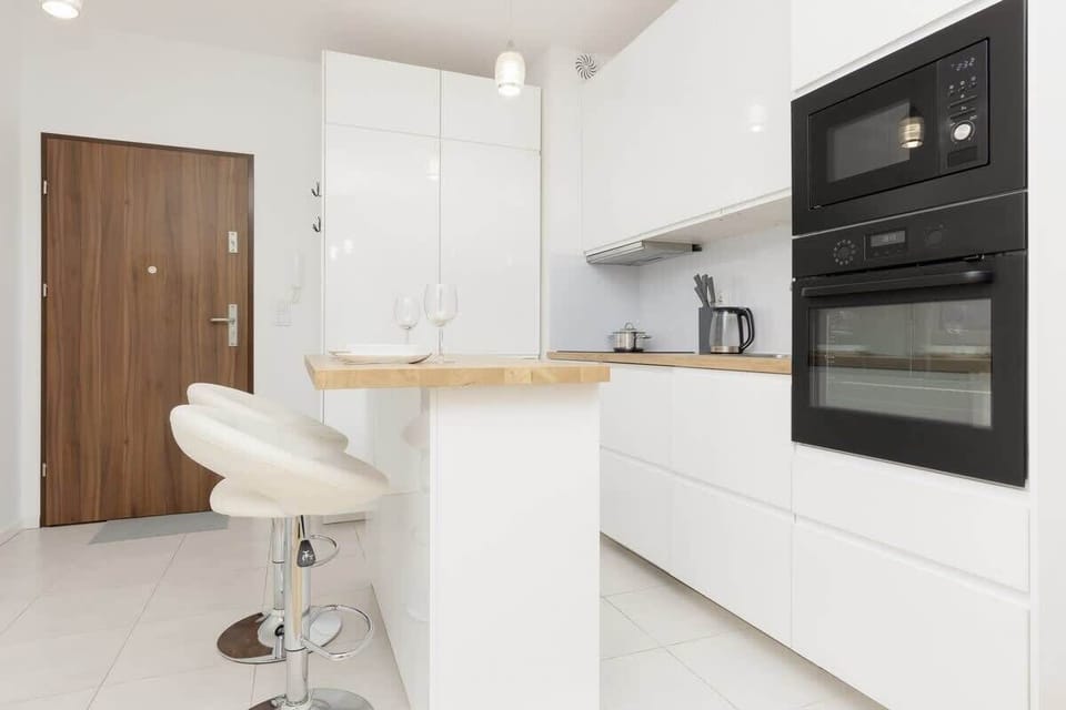Another close-up of the kitchen with sleek appliances and clean finishes, emphasizing a minimalist design.
