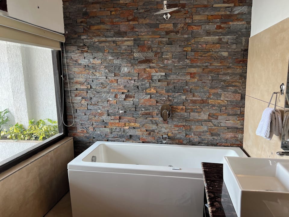 Luxury Suite | Bathroom | Designer toiletries, slippers, towels, soap