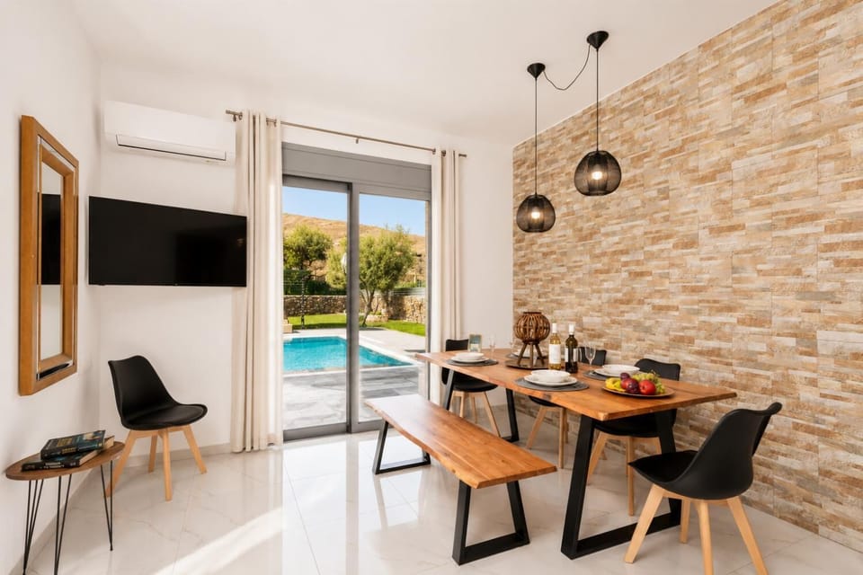 Open-plan living room with sofa, dining area, kitchen, A/C, WiFi internet, and satellite TV