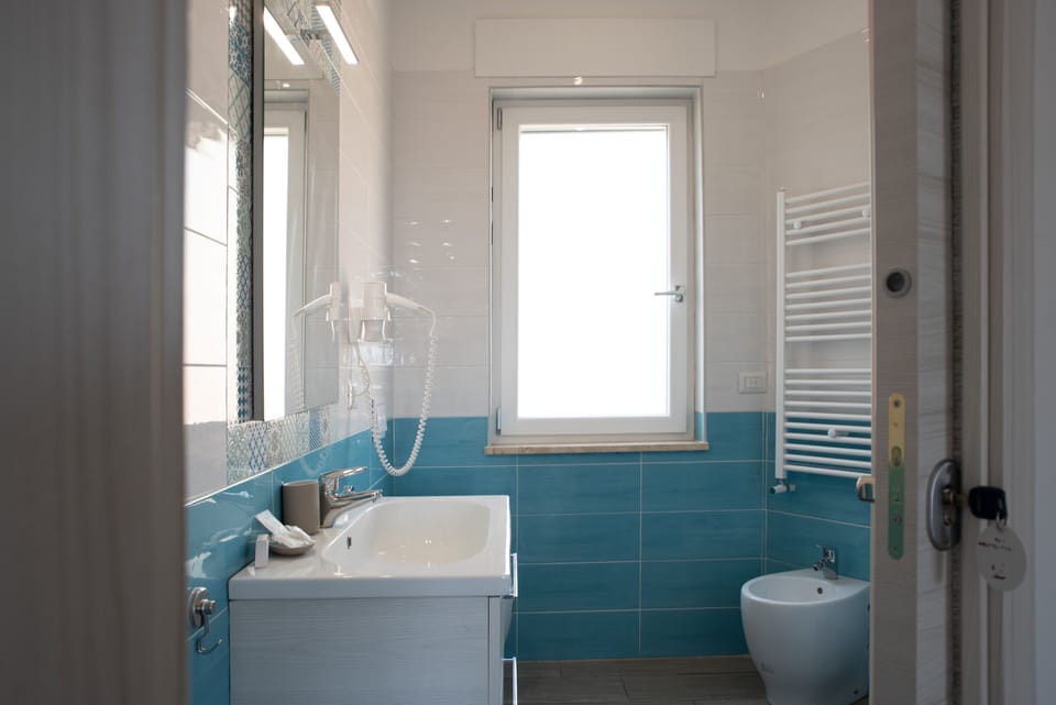 Family Room | Bathroom | Shower, rainfall showerhead, hair dryer, bathrobes