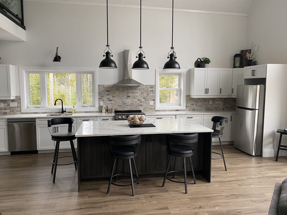 Open concept kitchen with dishwasher, drawer microwave, stove and refrigerator