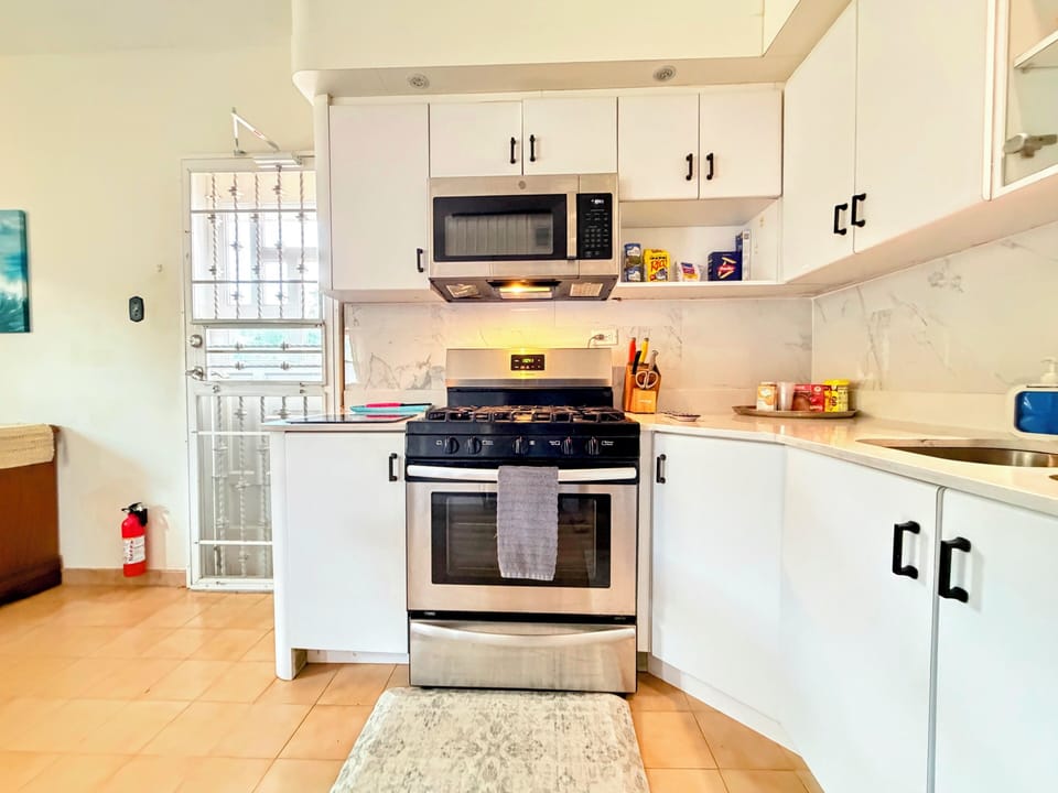 Bright modern kitchen with gas range and equiped