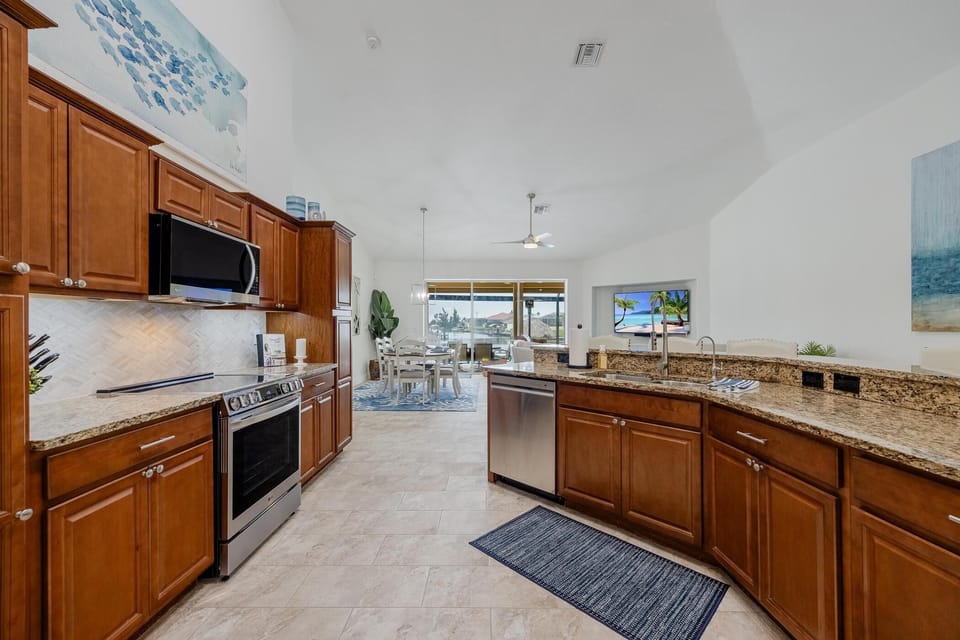 Kitchen with upgraded appliances and stocked with cooking equipment 