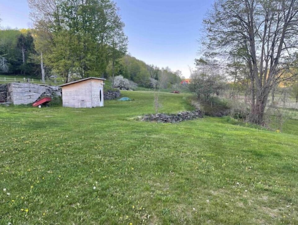 Unused chicken coup and groomed trail for easy access to pond.