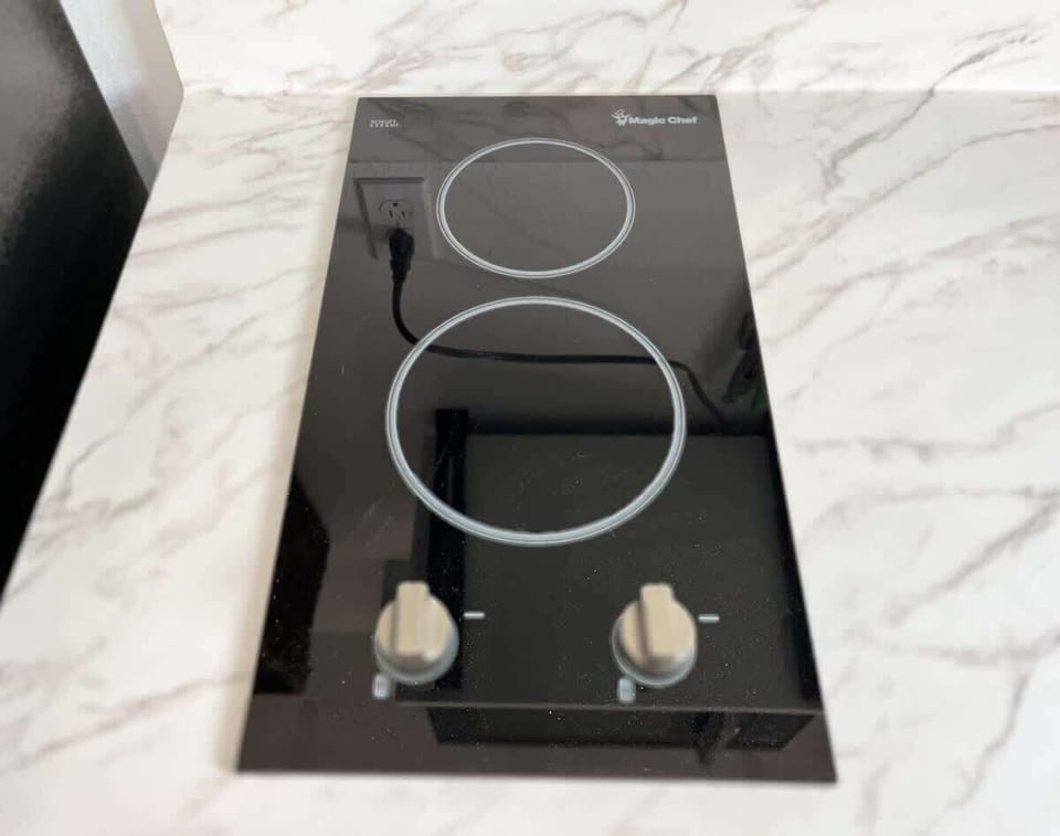 Sleek cooktop offering simple meal prep before heading out to enjoy tubing, kayaking, or exploring the nearby towns.