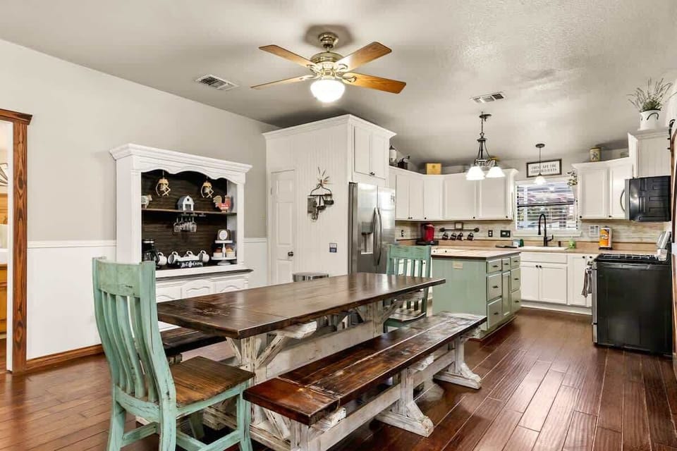 Fully equipped kitchen with modern appliances, large dining table, and plenty of space to cook and gather. Designed for group meals and easy entertaining.