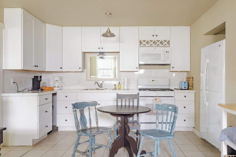 A bright and charming kitchen with modern appliances and a cozy dining nook, perfect for shared meals or morning coffee. Thoughtfully designed for comfort and convenience during your stay, Located at New Braunfels.