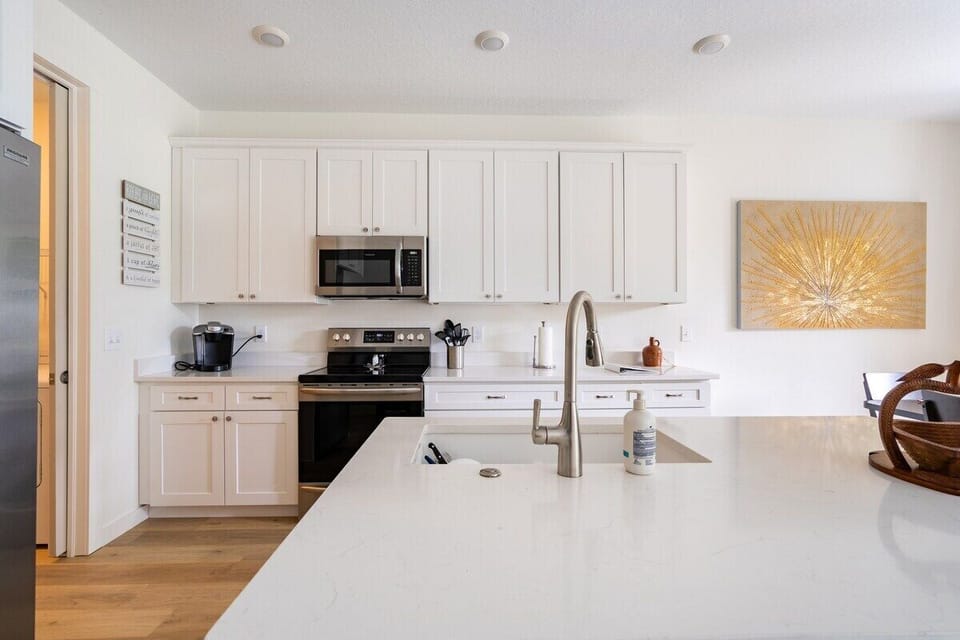 KITCHEN: From your seat at the kitchen island, the stove and oven await your culinary creations.