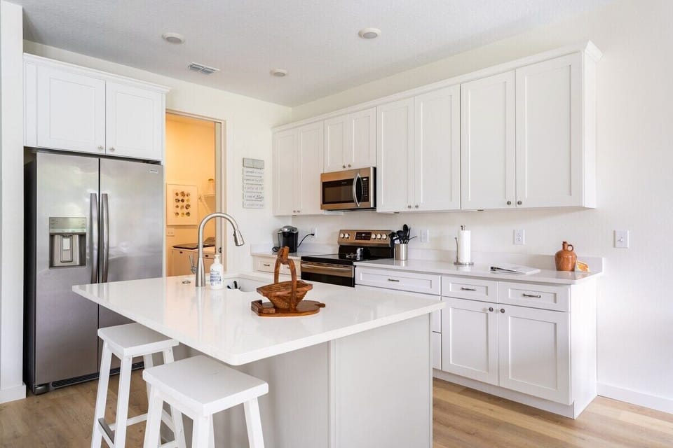 WELL-EQUIPPED KITCHEN: This area is where culinary adventures come to life.  The kitchen island takes center stage, providing ample workspace and a hub for casual dining.