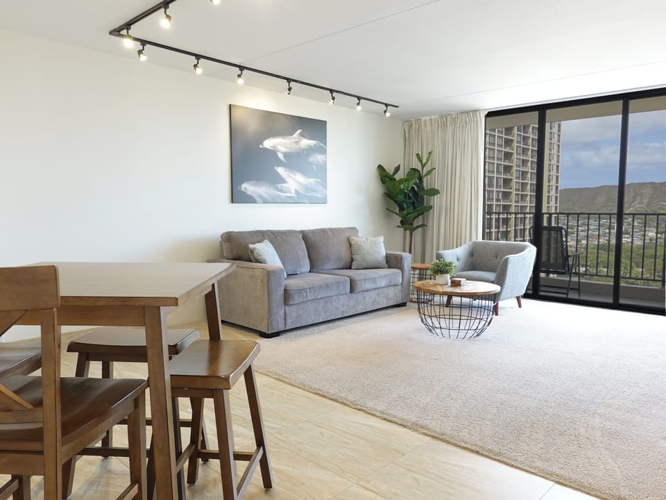 Living room with pull out sofabed, separate eating area.