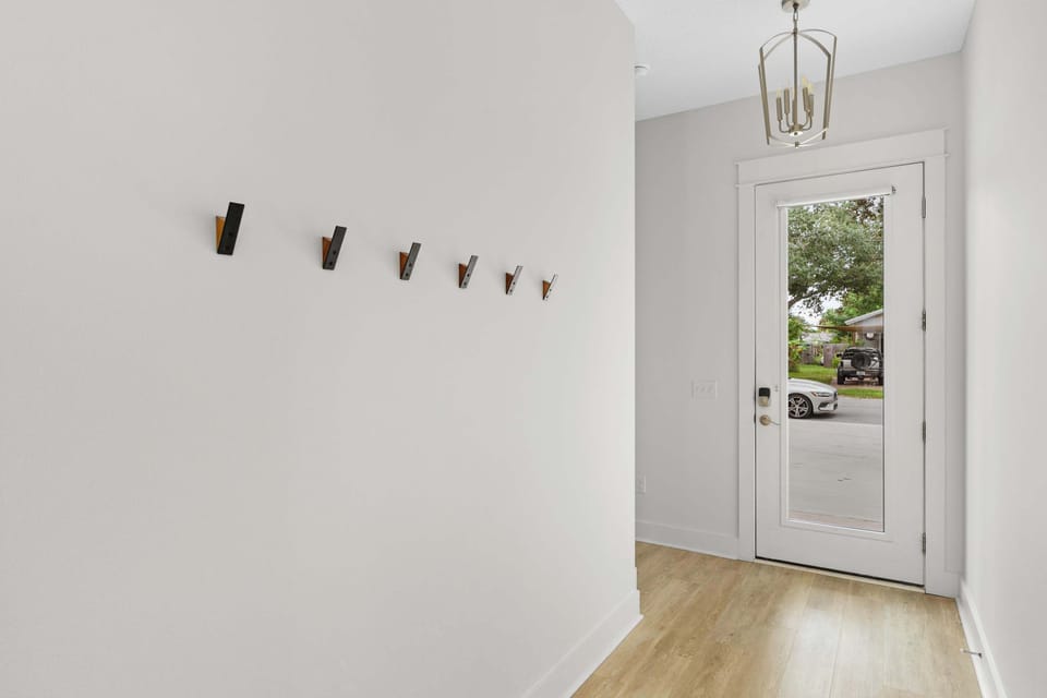 Step into a bright and welcoming entryway that sets the tone for your stay, featuring modern decor and plenty of space to greet guests. - The Sandbar - Panama City Beach, FL