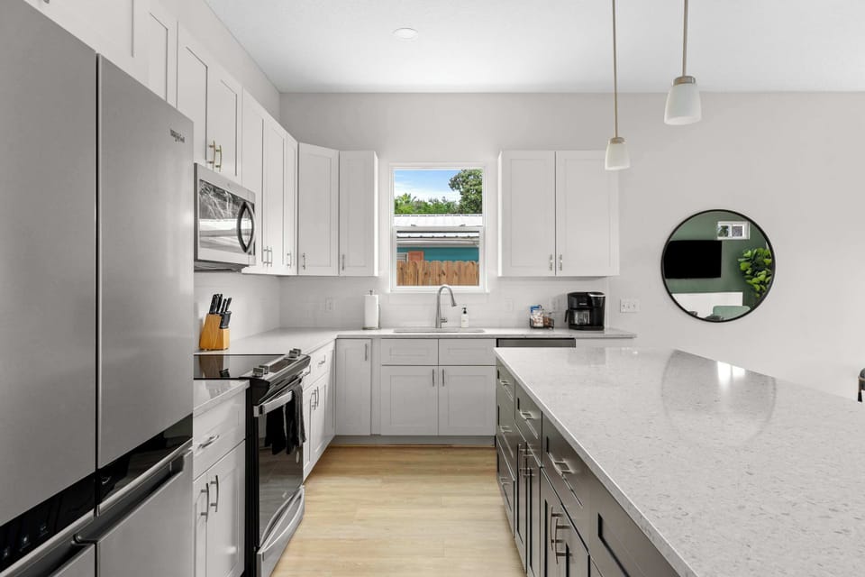 Prepare delicious meals in this spacious kitchen with high-end appliances, sleek countertops, and plenty of storage for all your cooking essentials. - The Sandbar - Panama City Beach, FL