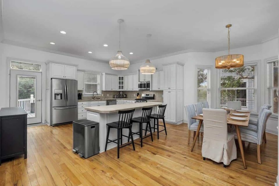Entertain with ease in the open concept kitchen and dining area, featuring modern appliances and plenty of space for your crew to cook, eat, and relax. - The Tiara - Murrells Inlet, SC