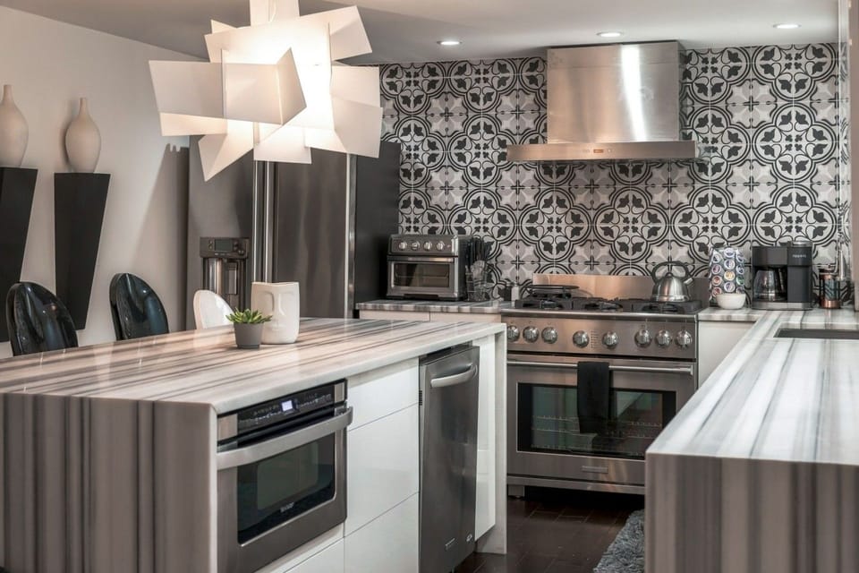 This sleek, fully equipped kitchen offers a beautiful, high-end space where preparing a meal feels less like a chore and more like a luxury experience.