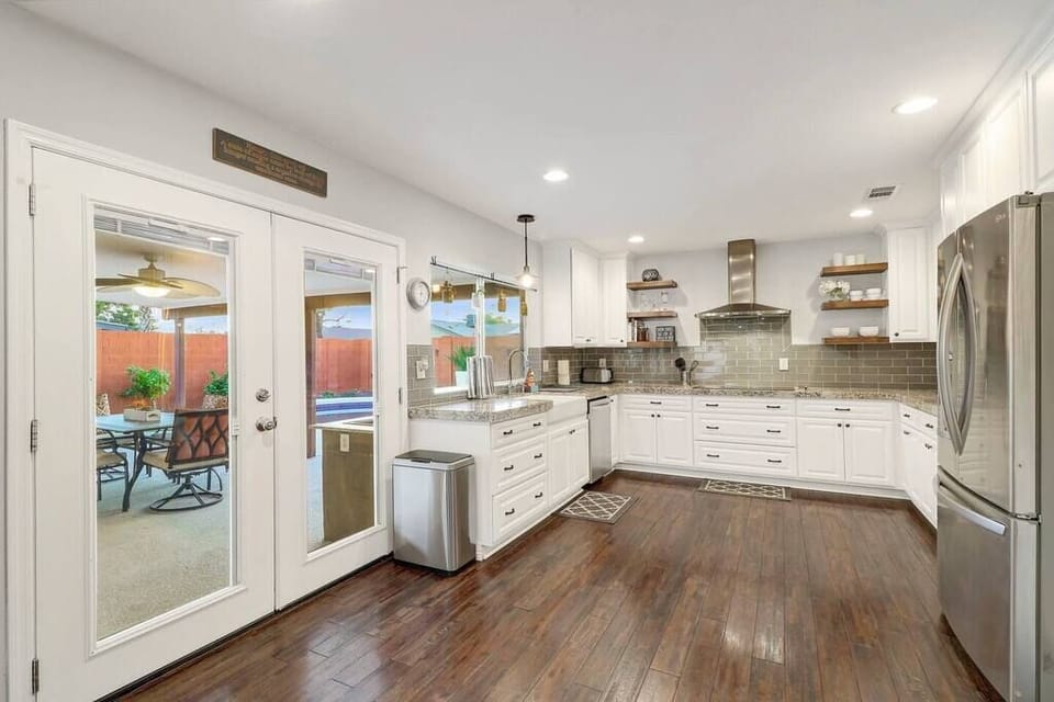 Open kitchen layout and french doors that open to the backyard dining table.