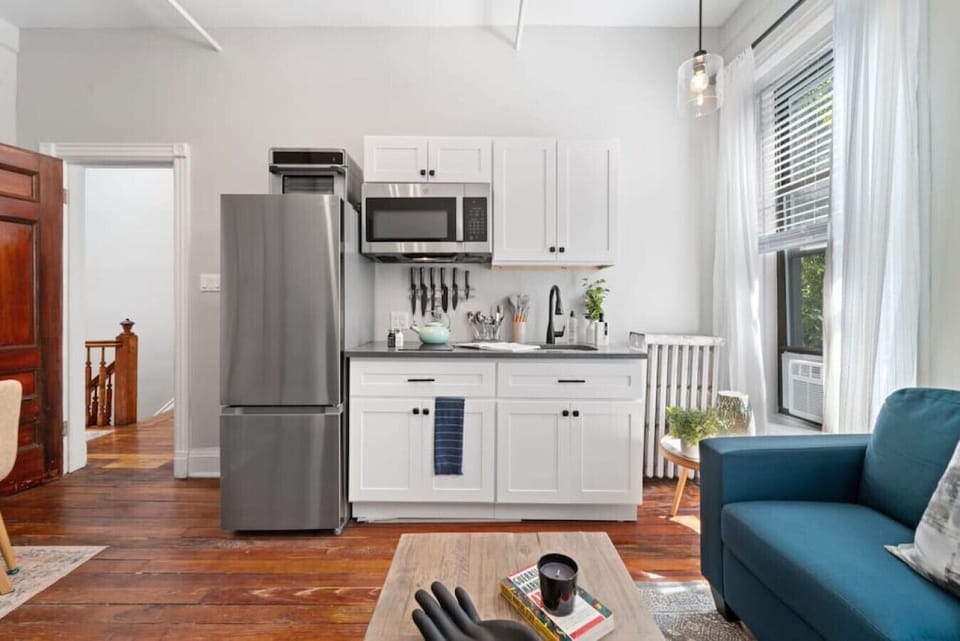 The compact kitchen is equipped with essential appliances, including a fridge, microwave, and air fryer. Despite its size, it offers convenience and functionality for preparing meals with modern amenities at your disposal.