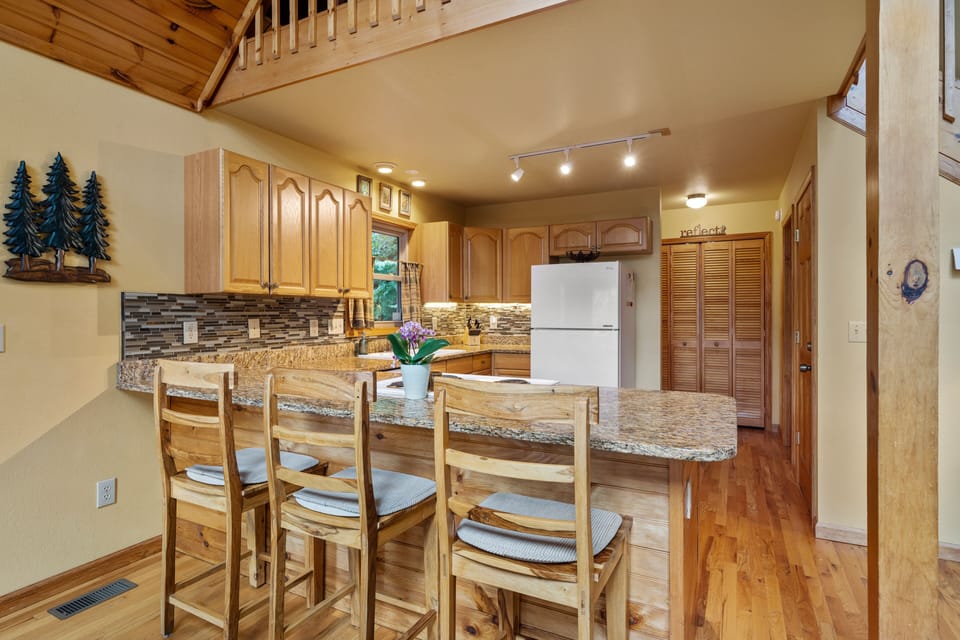 The dining room seats 4 and the kitchen bar seats 3 more