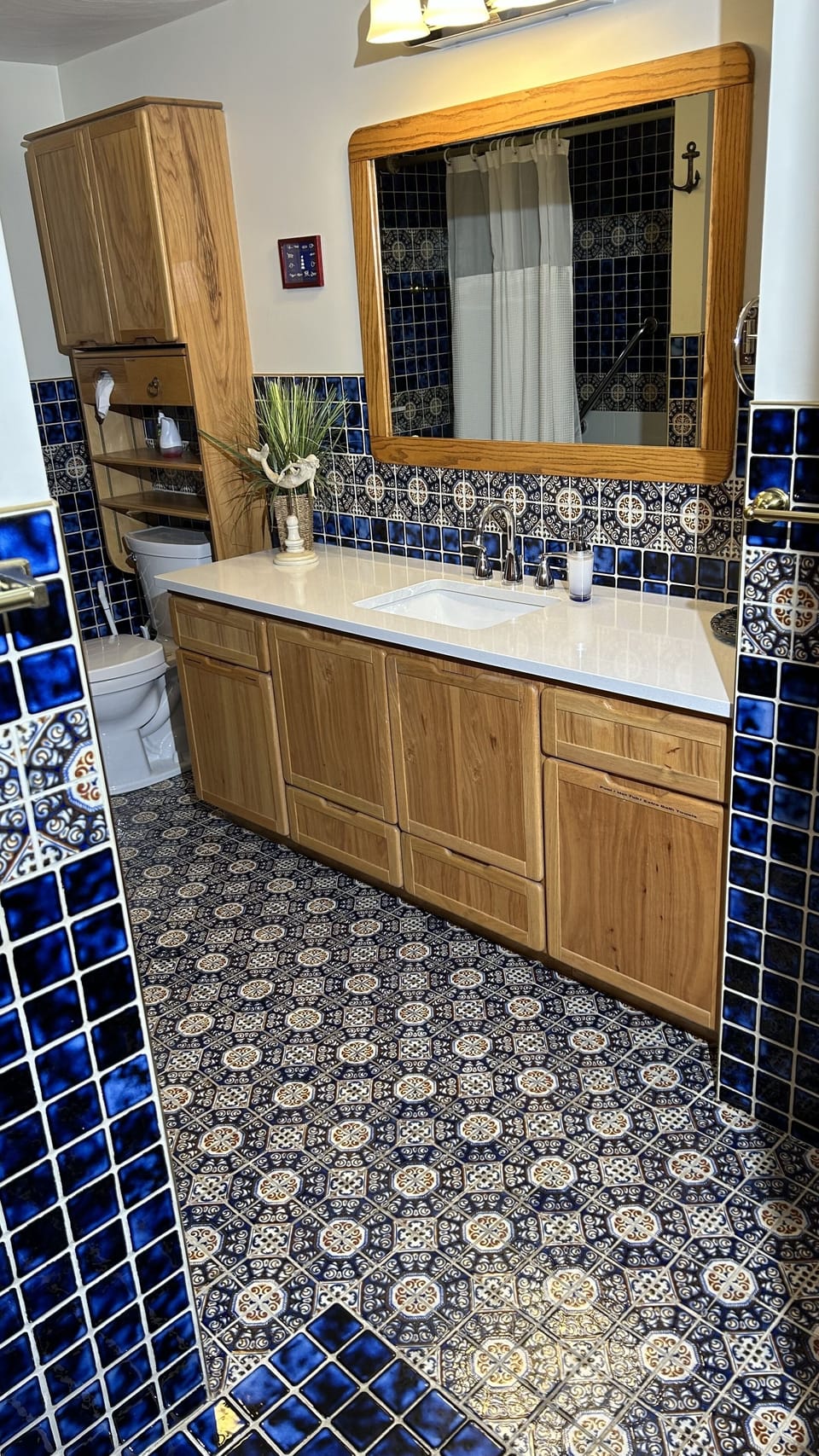 Large 1st Floor Bathroom has Long Countertop/Cabinet, Toilet, & Tub-Shower.