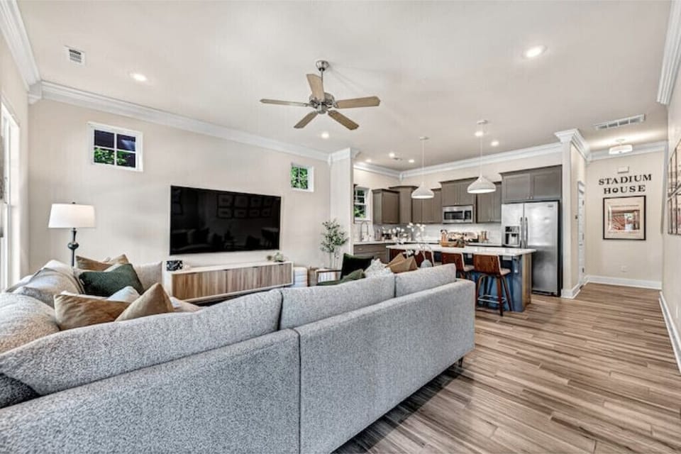 Enjoy Open-Concept Living boasting an 86" 4K TV & comfortable seating for all.