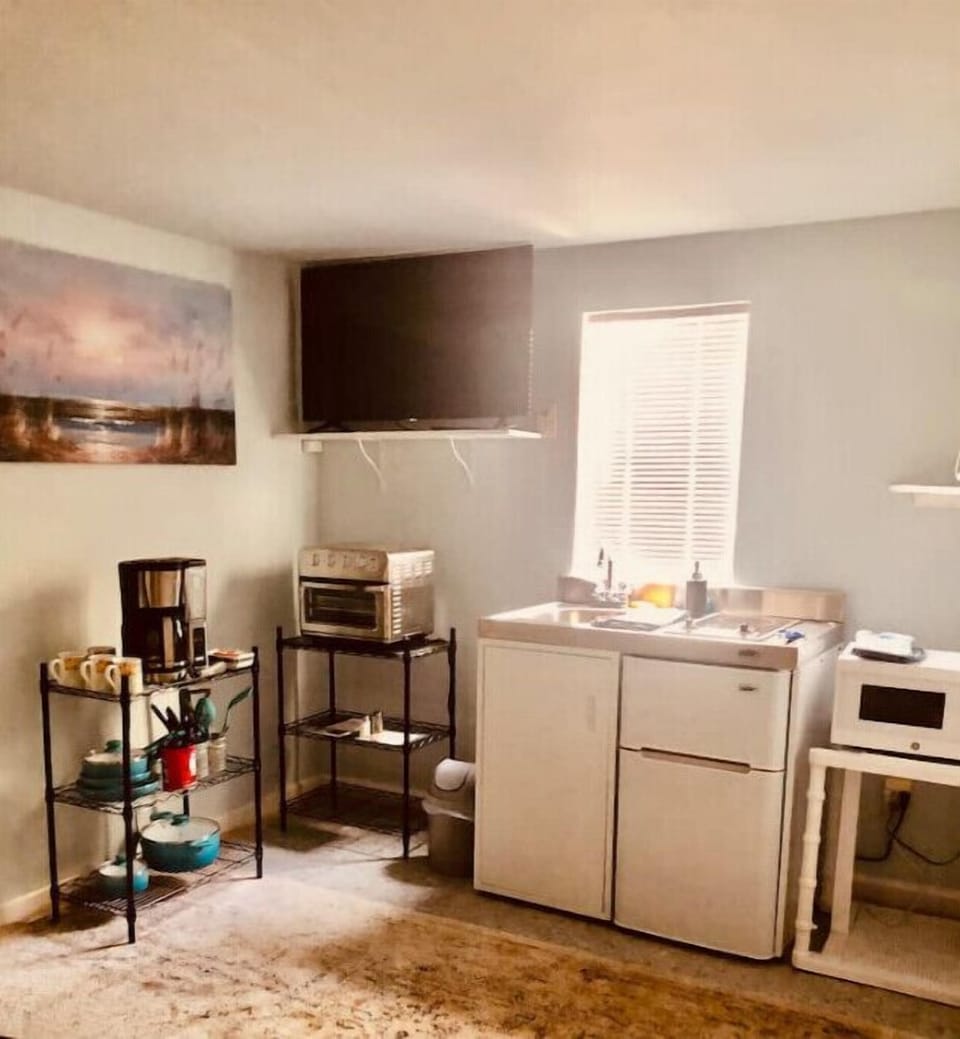 Mini kitchen, fridge, microwave, convection oven and coffee maker, pods, TV.