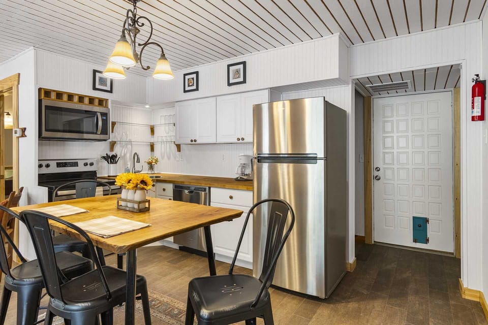 Your cozy country kitchen includes appliances (including a dishwasher), cooking and dining ware, utensils, and glasses.