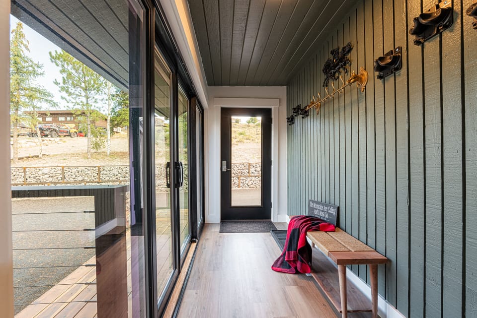 Upper-level main entrance with bench and coat hooks