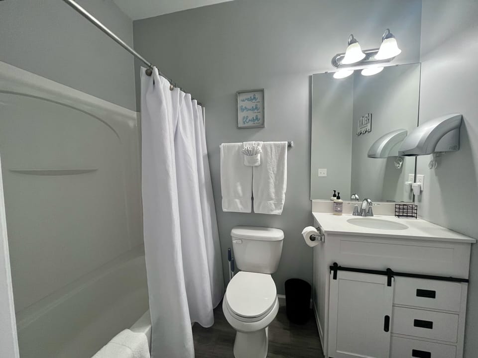 Bathroom 2 - shower/tub combo, vanity, toilet.