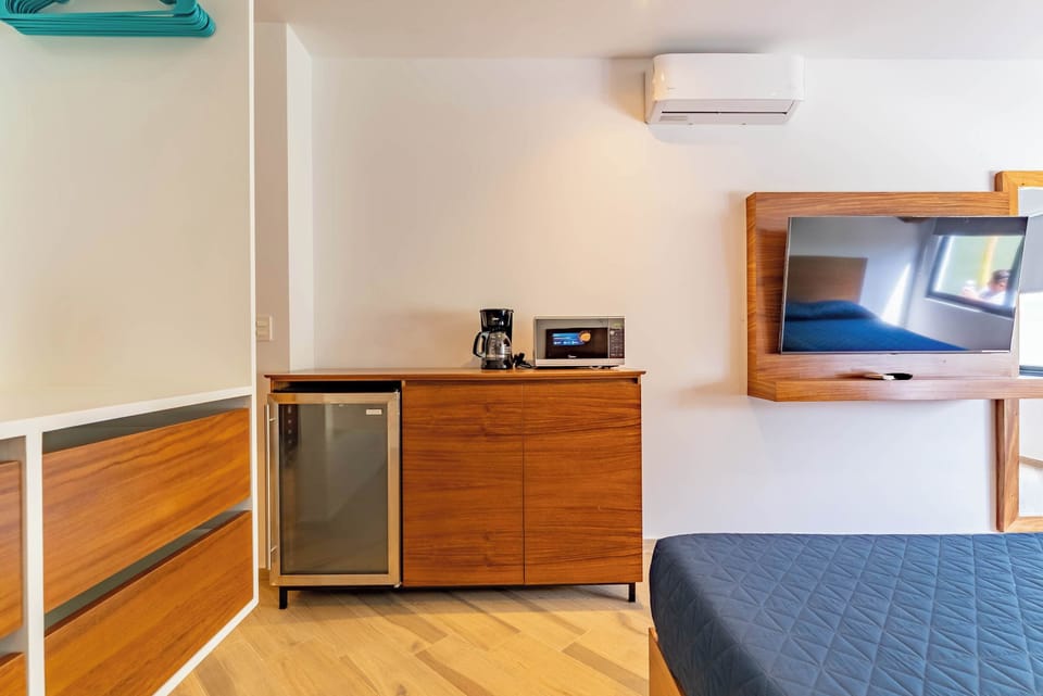 Bedroom 2 | Comfortable sleeping space with storage, mini fridge, and AC.