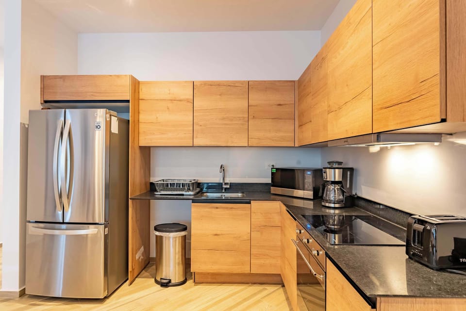 Kitchen | Well-appointed kitchen featuring vitroceramic cooktop, microwave, and oven.