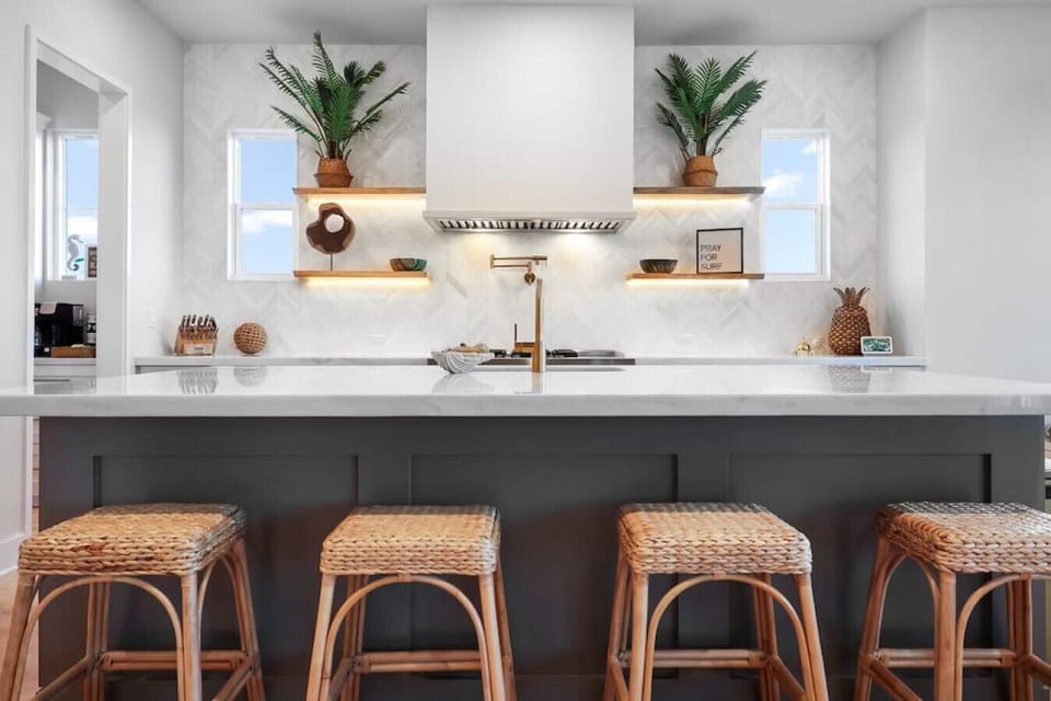 Chef’s kitchen in simple, elegant design — with a spacious island, double-oven, 6-burner stove with a built-in griddle, oversized fridge, coffee bar, and all the small appliances and tools you’ll need to cook with ease